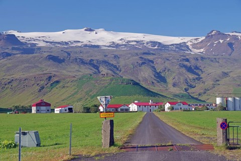 Farm in front of high mountains