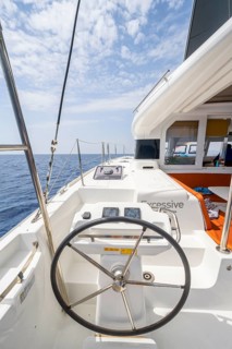 Steering wheel in the cockpit on the deck of a sailing catamaran