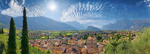 Old idyllic town surrounded by mountains with the Collegiata dell'Assunta church and fascinating sky