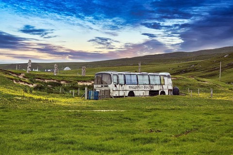Discarded bus in a meadow