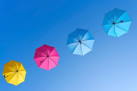Coloured umbrellas against a blue sky