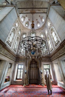 He performs the ritual prayers of Islam in Eyup Sultan