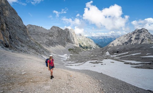 Hiker crossing a scree field