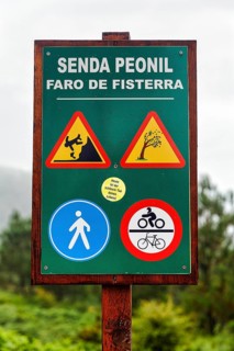Wooden sign pedestrian way with traffic signs and warnings