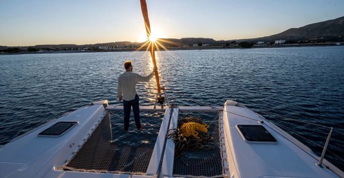 Young man standing by the foresail
