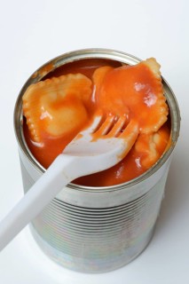 Ravioli in tin and plastic fork