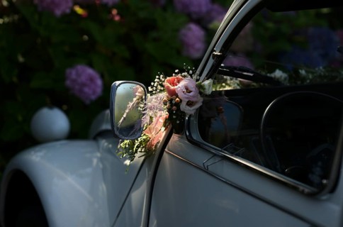 Wedding decoration on the wing mirror of a car