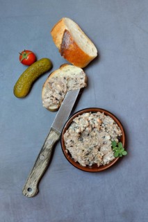 A bowl of meat terrine and slice of bread