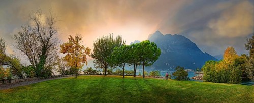 Breathtaking sunset on Lake Garda with hiker