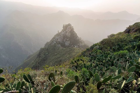 View of rock formation and mountain range in the evening haze