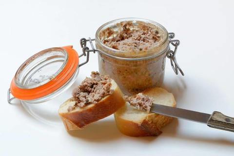 A jar of meat terrine and slices of bread