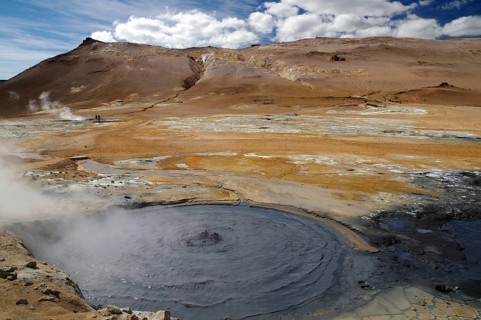 Hot mud springs bubbling in geothermal landscape with different colours