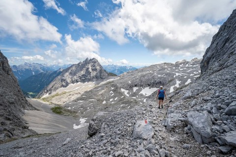 Hiker crossing a scree field