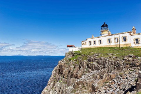 Lighthouse with foghorn on cliff