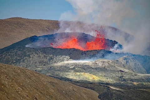 Lava fountains bubbling in a volcanic crater