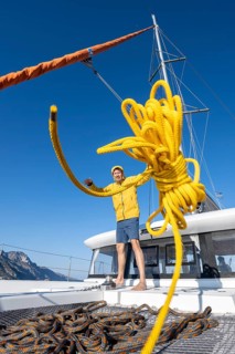 Sailor throws a yellow rope towards the camera