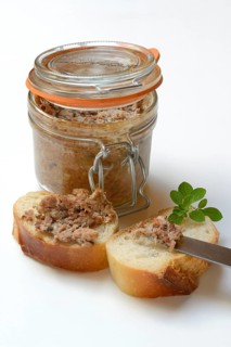 A jar of meat terrine and slices of bread