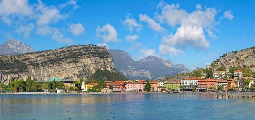Coastal town with colourful houses and the rocky mountain Monte Brione