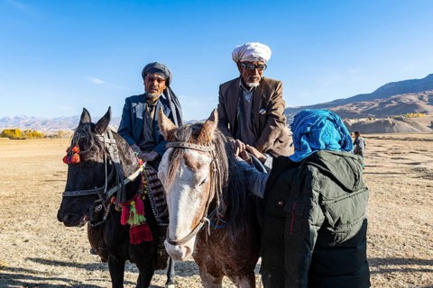 Old men on their horses at a Buzkashi game