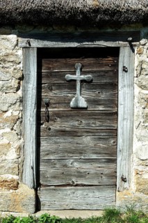 Wooden cross on a door of farm