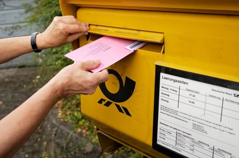 Election letter is put into Deutsche Post letterbox