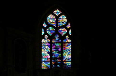 Stained glass window in the chancel of La Chapelle de Notre Dame de Bonne Nouvelle et sa fontaine