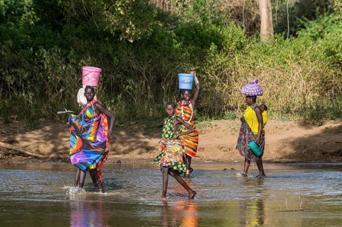 Women walking through a river bed
