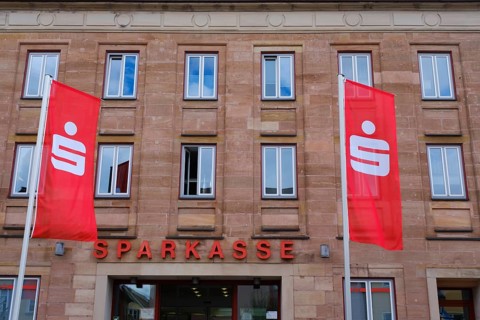 Flags in front of the facade of the savings bank