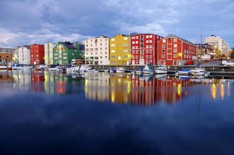 Illuminated houses reflected in a body of water