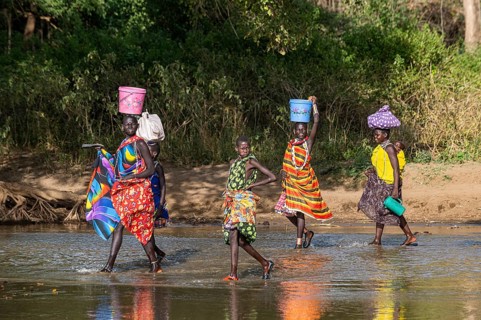 Women walking through a river bed