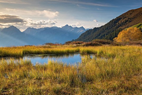 Autumn mountain landscape with small pond