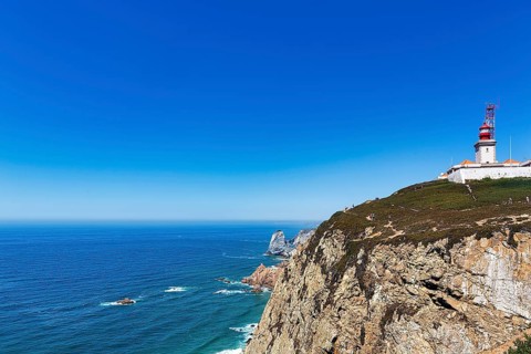 Lighthouse on rocky coast on the Atlantic Ocean