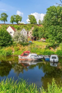 View across the moat to half-timbered houses