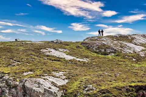 Walkers on rocky coast