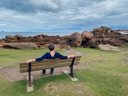 Elderly woman sitting on bench