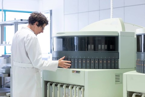 Technician processing samples with laboratory equipment in a histology laboratory