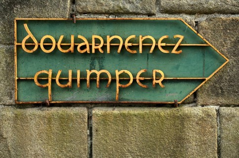 Old road sign shows way to Douarnenez and Qimper