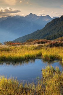Autumn mountain landscape with small pond