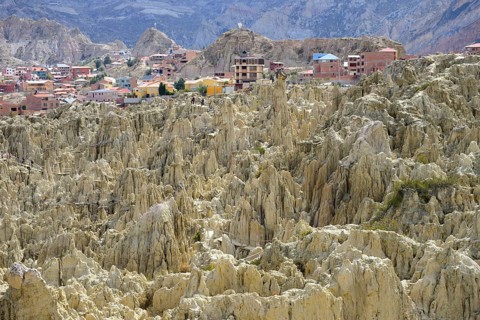 Residential houses behind the bizarre rock formations in Valle de la Luna
