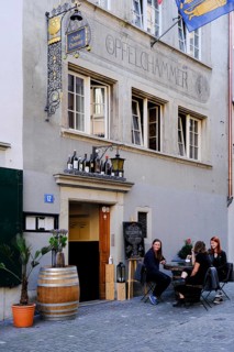 Young people sitting in front of a pub