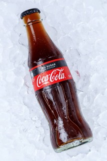 Coca Cola Coca-Cola Coke Zero Sugar in a bottle lemonade soft drink drink on ice cube ice cubes