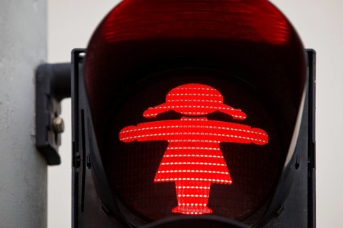 Pedestrian traffic light with red traffic light woman