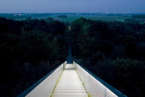 View from the illuminated sky staircase into the landscape at dawn