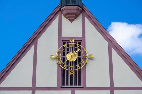 Clock on the gable of the town hall in Gemuenden am Main