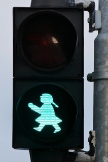 Pedestrian traffic light with green traffic light woman