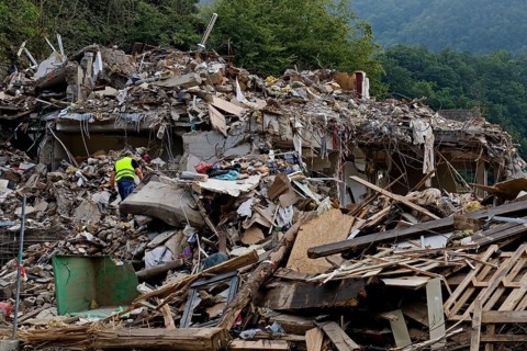 A man in mountains of rubble and rubbish