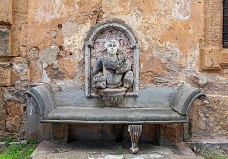 Stone bench with wall relief