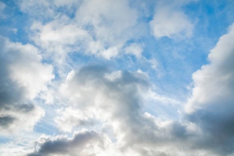 Stratocumulus clouds and blue sky windows form spectacular cloud formation in the sky during Foehn storm