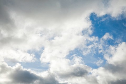 Stratocumulus clouds and blue sky windows form spectacular cloud formation in the sky during Foehn storm