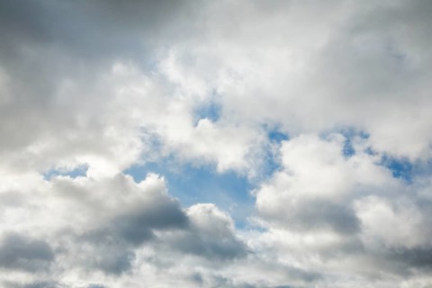 Stratocumulus clouds and blue sky windows form spectacular cloud formation in the sky during Foehn storm